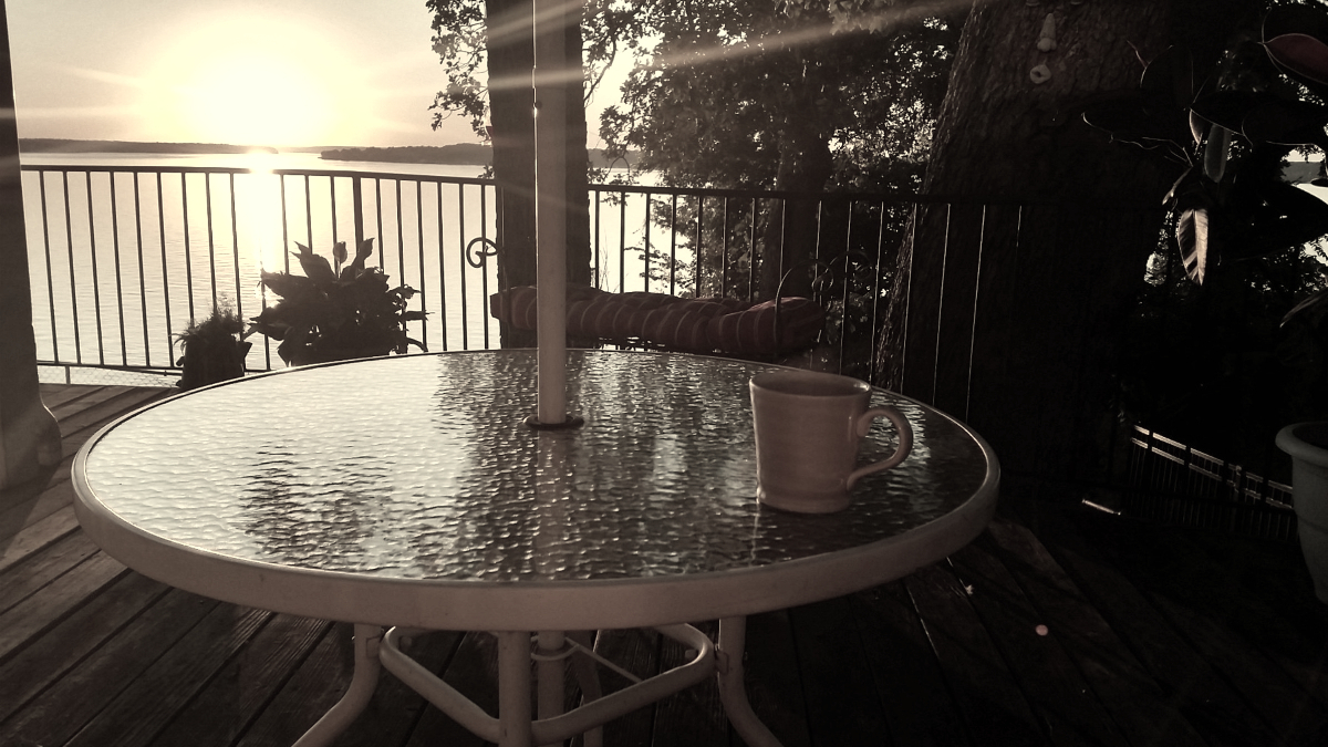 Morning sunlight across Grand Lake from a lakefront patio.